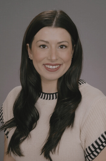 This is an image of our Braintree estate planning law firm's administrative assistant, Victoria Illacqua. Victoria has dark brown eyes and long black hair down the middle and a large bright smile.